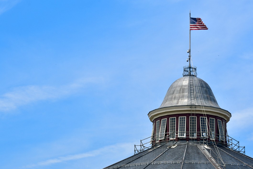 Wispy Clouds Behind the Flag of the Roundhouse