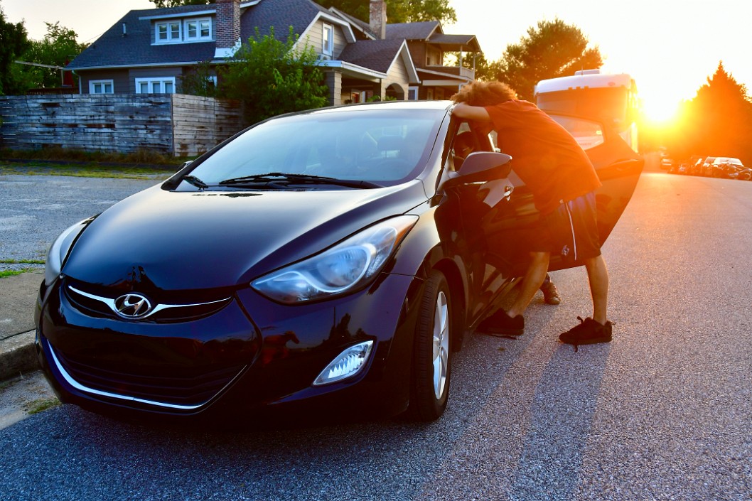 Malachi Leaning on the Car